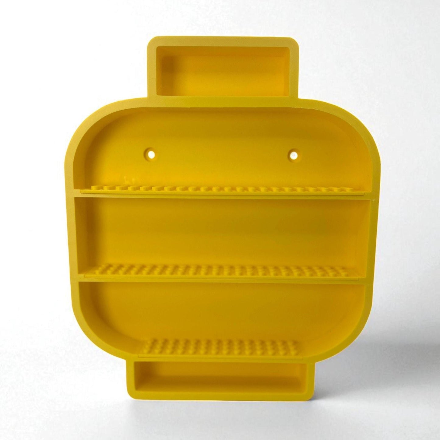 Yellow Lego inspired 3D printed minifigure head shaped shelf with open compartments for displaying small toys or collectibles.