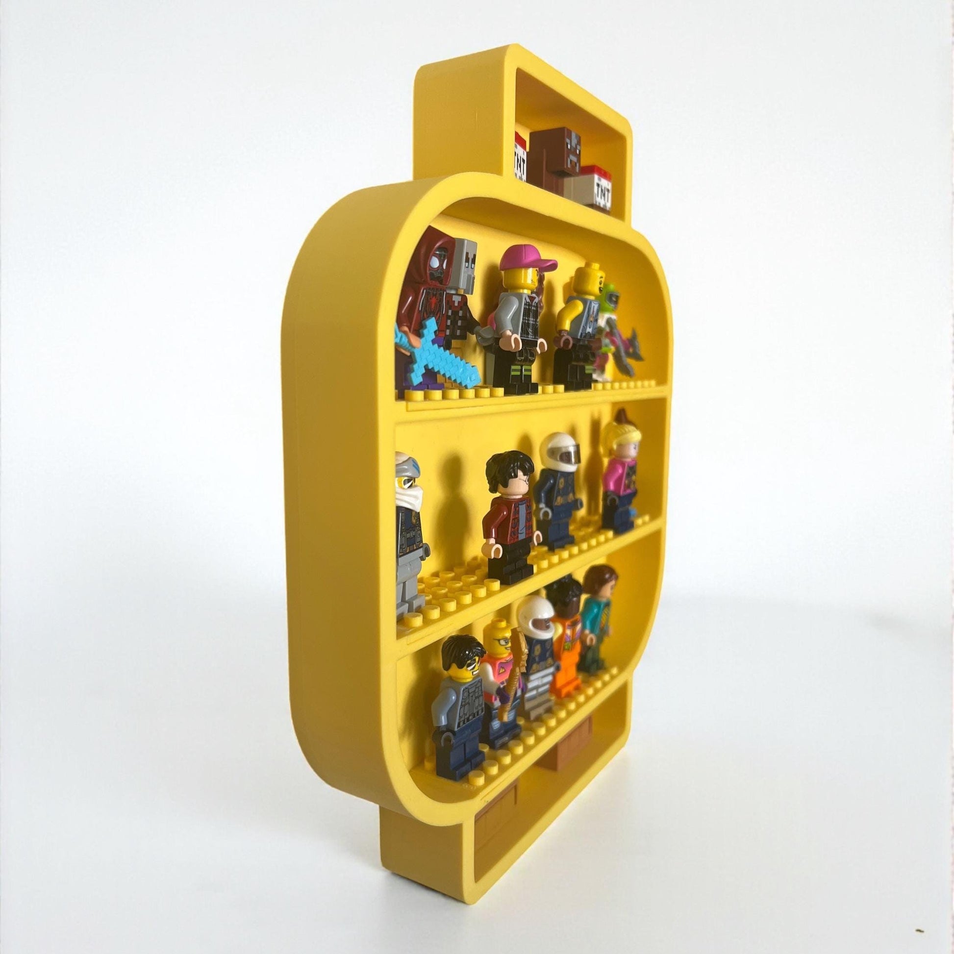 Side angle view of yellow LEGO-style minifigure head shelf showing depth and compartments filled with toy minifigures